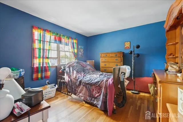 a bedroom with two beds and a window