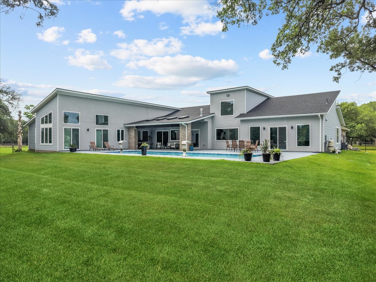 7627 Scott Avenue Manvel, TX 77578 - Photo 2 of 50 50ft salt water pool, spacious covered patio, and lush green grass!
