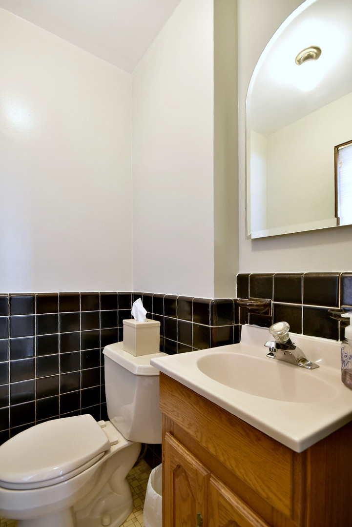 196 Fairfield Avenue Elmhurst, IL 60126 - Photo 34 of 44 a bathroom with a sink a toilet and a mirror
