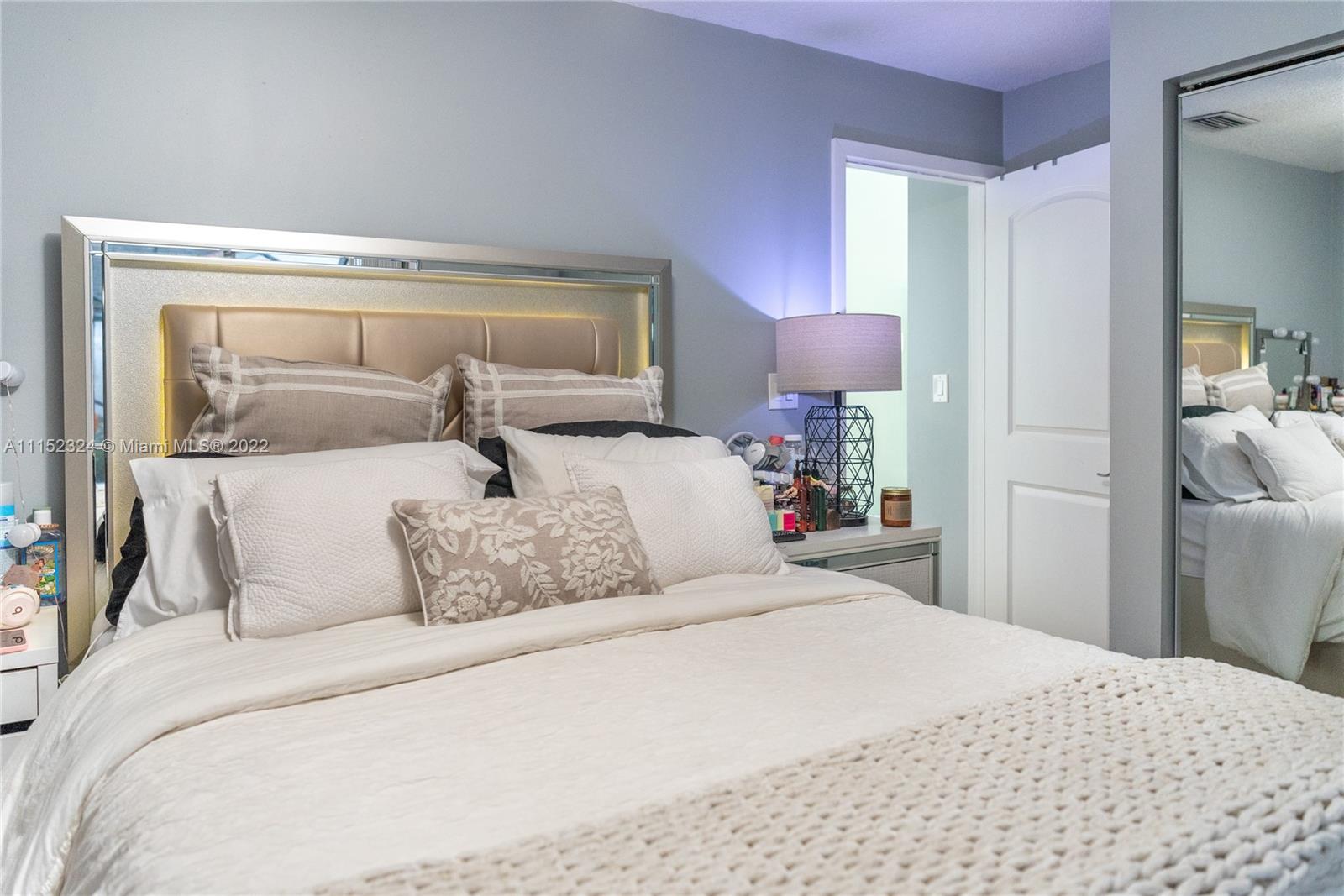 21356 Summertrace Circle Boca Raton, FL 33428 - Photo 12 of 21 a bedroom with a bed and a mirror