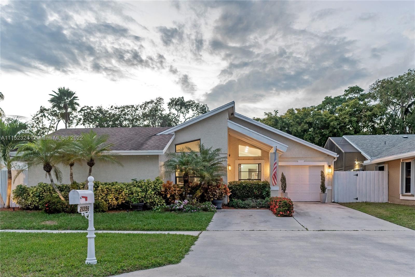 21356 Summertrace Circle Boca Raton, FL 33428 - Photo 21 of 21 a view of a white house next to a yard with big trees