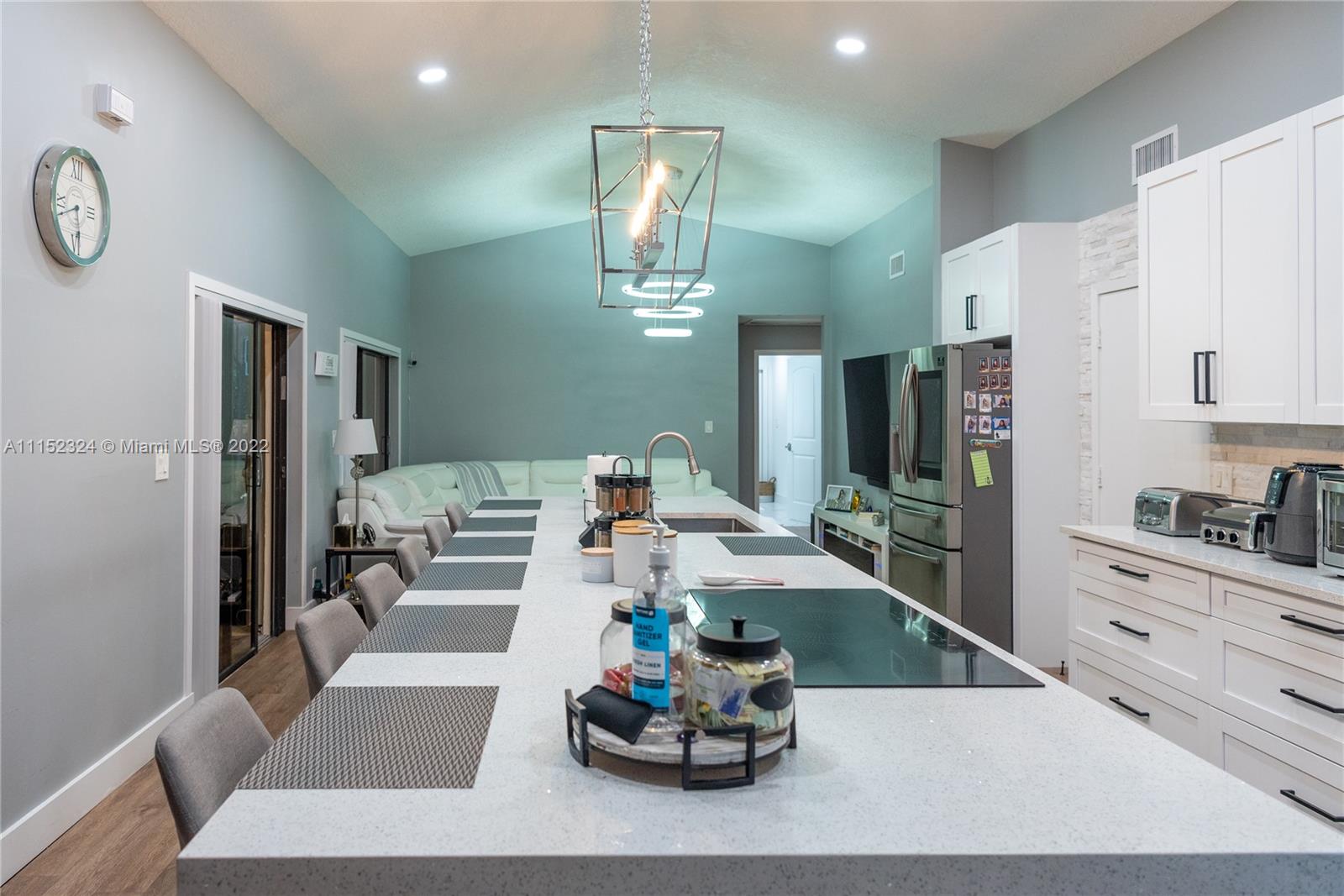 21356 Summertrace Circle Boca Raton, FL 33428 - Photo 5 of 21 a living room with furniture kitchen view and a chandelier
