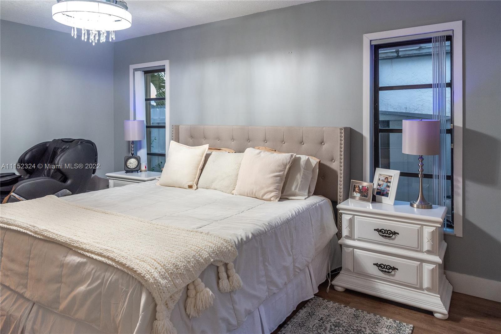 21356 Summertrace Circle Boca Raton, FL 33428 - Photo 7 of 21 a bedroom with a bed and a chandelier