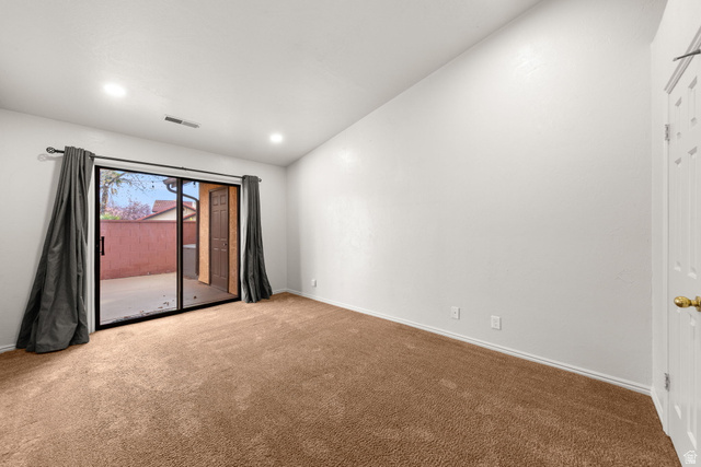 301 South 1200th Street East, Unit 31 St. George, UT 84790 - Photo 8 of 21 Unfurnished room with carpet floors, lofted ceiling, and recessed lighting