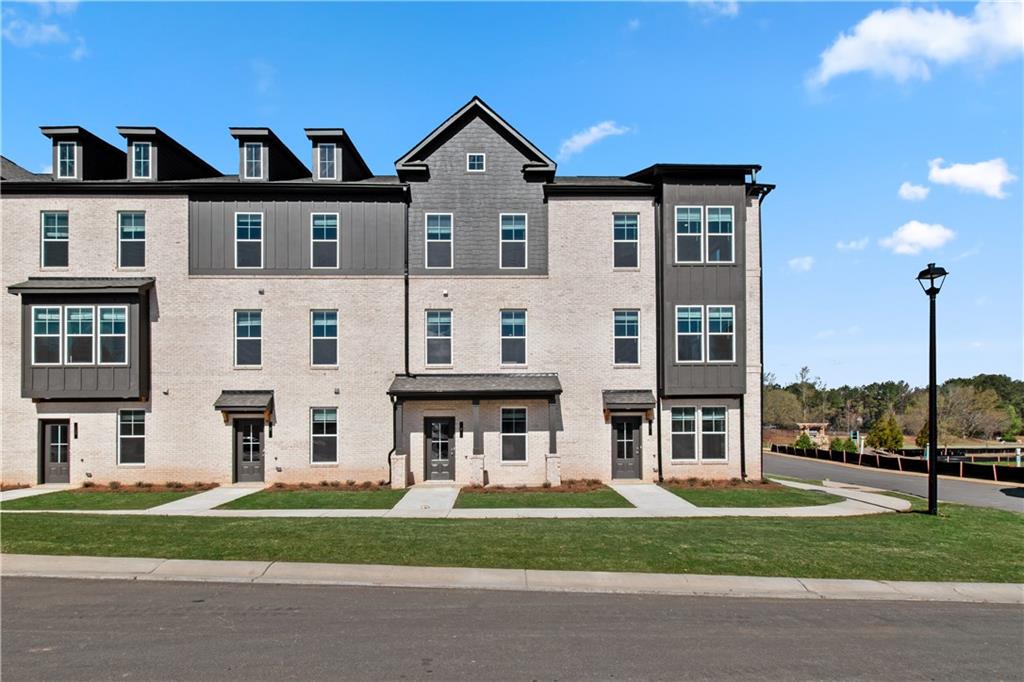a view of a big house with a big yard and plants