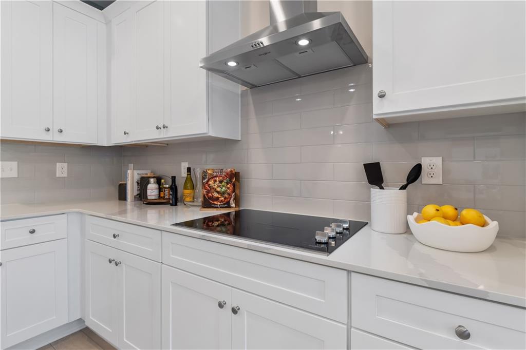 204 Daybreak Lane Newnan, GA 30265 - Photo 18 of 48 a kitchen with white cabinets and a sink