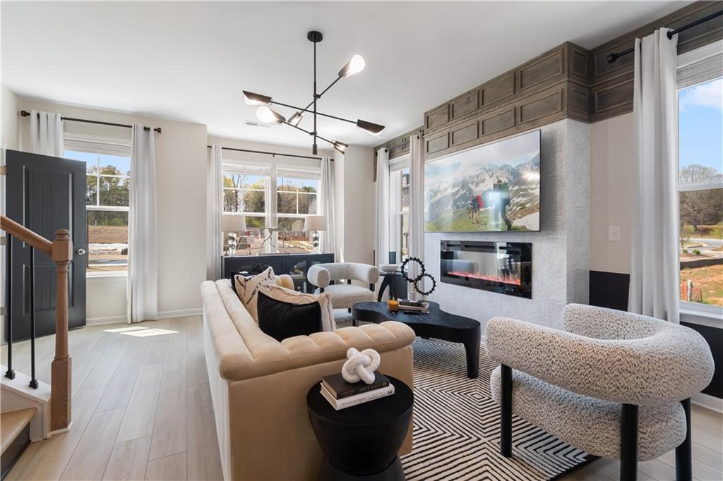 204 Daybreak Lane Newnan, GA 30265 - Photo 22 of 48 a living room with furniture a large window and a flat screen tv