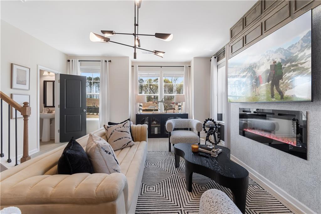 204 Daybreak Lane Newnan, GA 30265 - Photo 23 of 48 a living room with furniture a flat screen tv and a fireplace