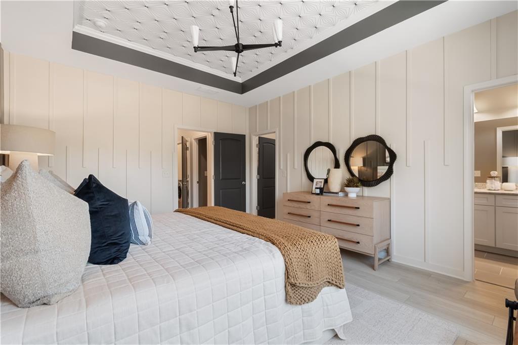 204 Daybreak Lane Newnan, GA 30265 - Photo 38 of 48 a bedroom with a bed and a chandelier