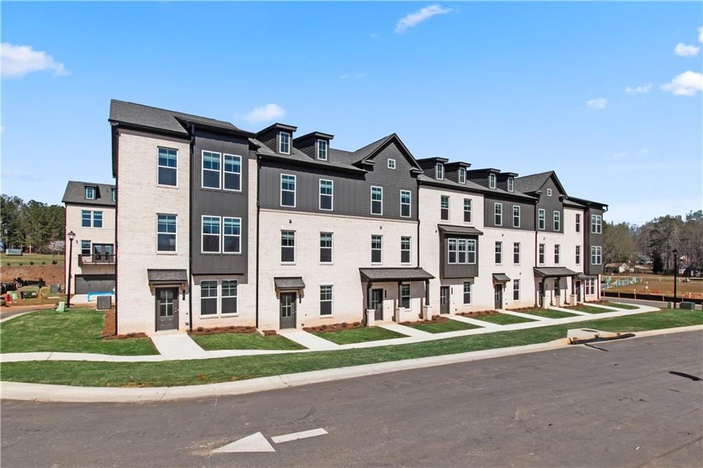 204 Daybreak Lane Newnan, GA 30265 - Photo 4 of 48 a front view of residential houses with yard and road