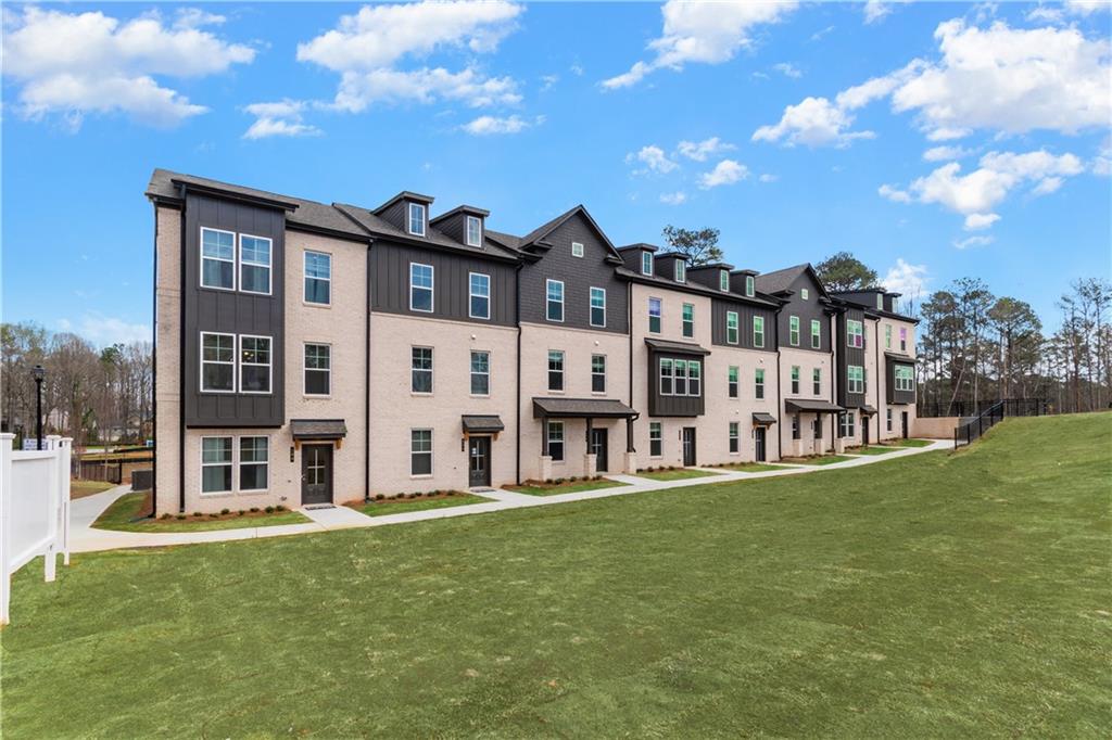 204 Daybreak Lane Newnan, GA 30265 - Photo 46 of 48 a large building with a yard in front of it