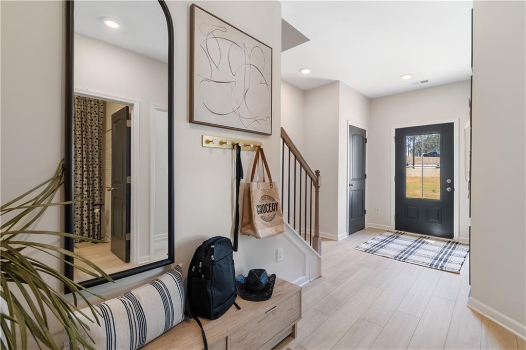 204 Daybreak Lane Newnan, GA 30265 - Photo 8 of 48 a view of a hallway with wooden floor and staircase
