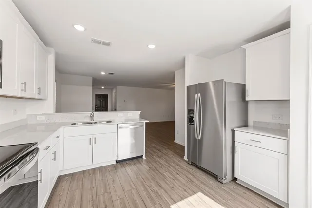 a kitchen with a sink stainless steel appliances and cabinets
