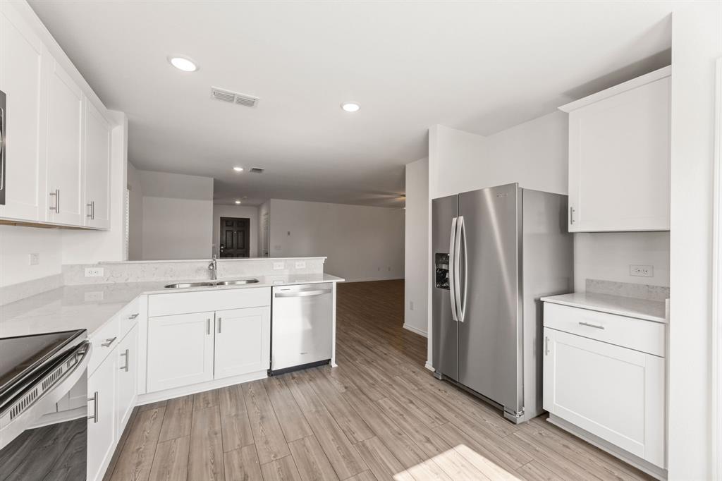 816 Breakwater Drive Princeton, TX 75407 - Photo 12 of 30 a kitchen with a sink stainless steel appliances and cabinets