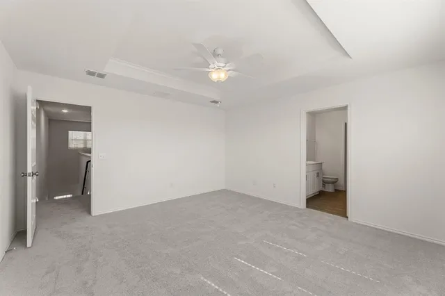 a view of an empty room with a ceiling fan