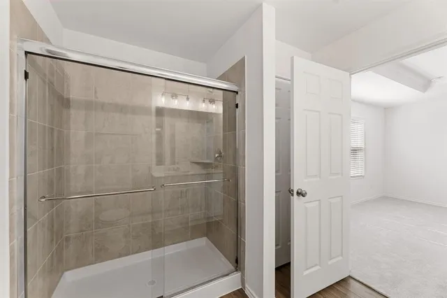 a bathroom with a glass shower door