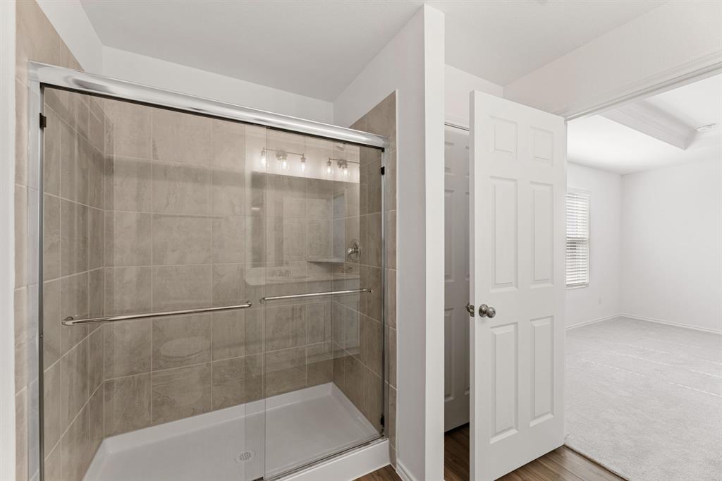 816 Breakwater Drive Princeton, TX 75407 - Photo 19 of 30 a bathroom with a glass shower door