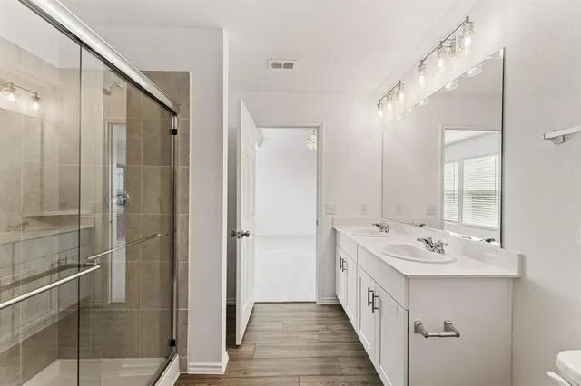 a bathroom with a double vanity sink and mirror
