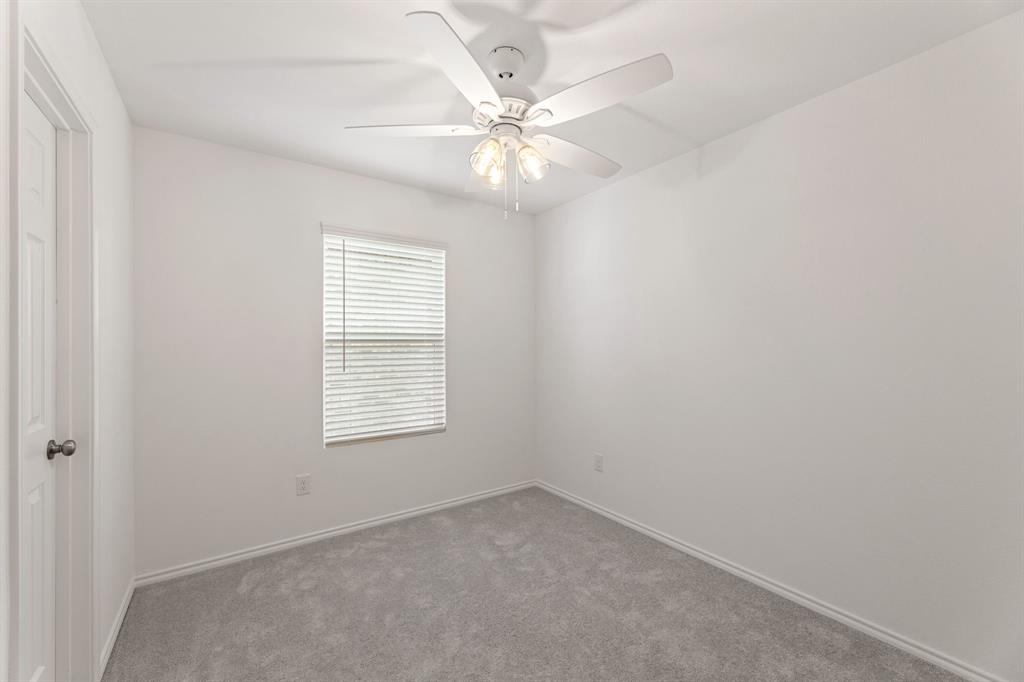 816 Breakwater Drive Princeton, TX 75407 - Photo 22 of 30 an empty room with a window and a fan