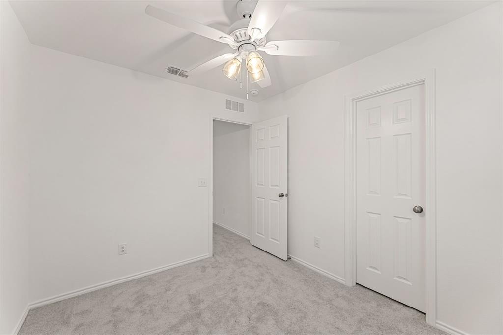 816 Breakwater Drive Princeton, TX 75407 - Photo 23 of 30 an empty room with a chandelier fan and closet