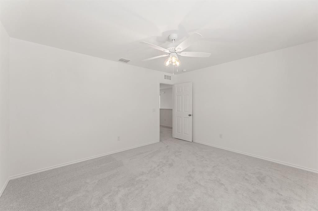 816 Breakwater Drive Princeton, TX 75407 - Photo 25 of 30 an empty room with a ceiling fan and a fan