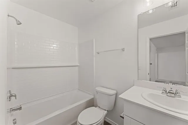 a bathroom with a toilet a sink and bathtub