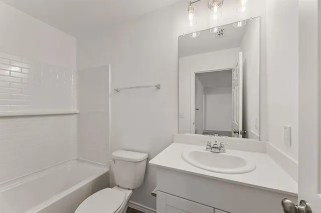 a bathroom with a toilet a sink and a bathtub