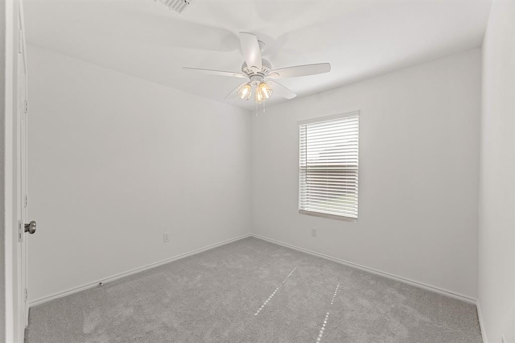 816 Breakwater Drive Princeton, TX 75407 - Photo 7 of 30 an empty room with a window and ceiling fan
