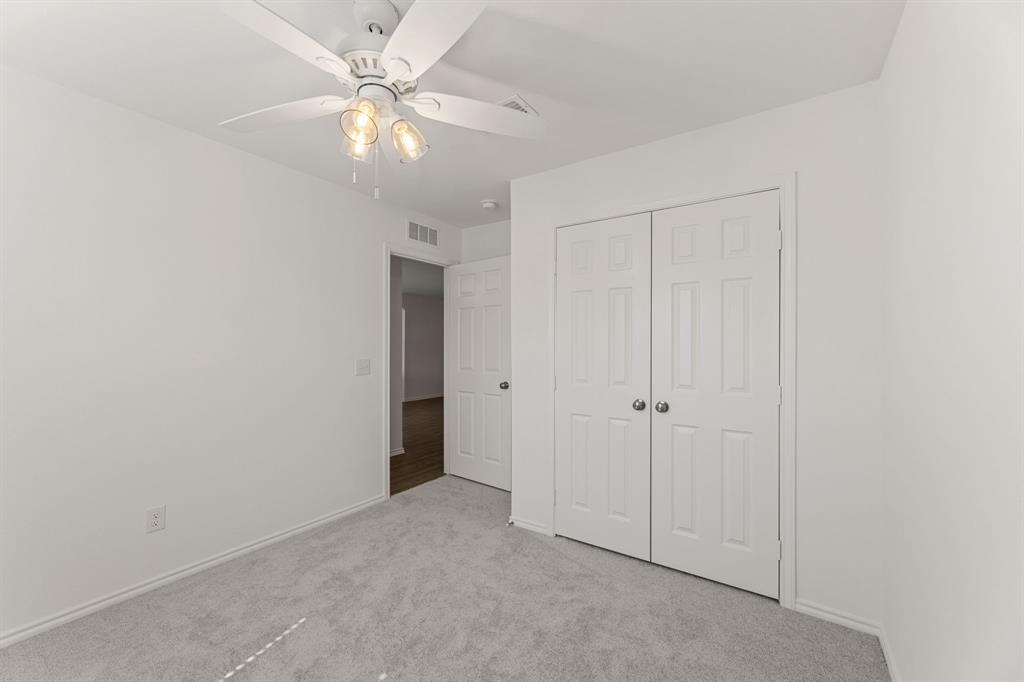 816 Breakwater Drive Princeton, TX 75407 - Photo 8 of 30 an empty room with fan and a ceiling fan
