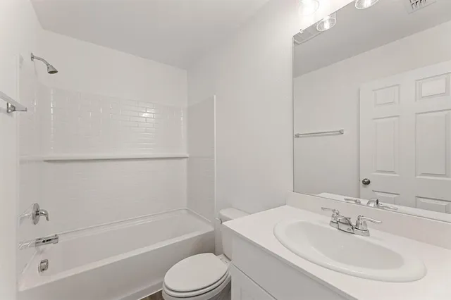 a bathroom with a toilet a sink and a bathtub