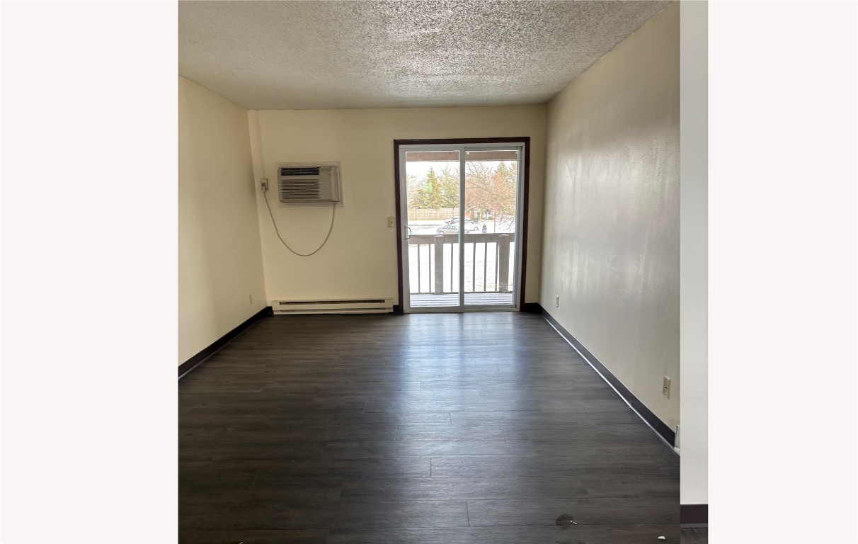 631 West Sycamore Street Columbus Grove, OH 45830 - Photo 7 of 10 a view of an empty room with wooden floor and a window