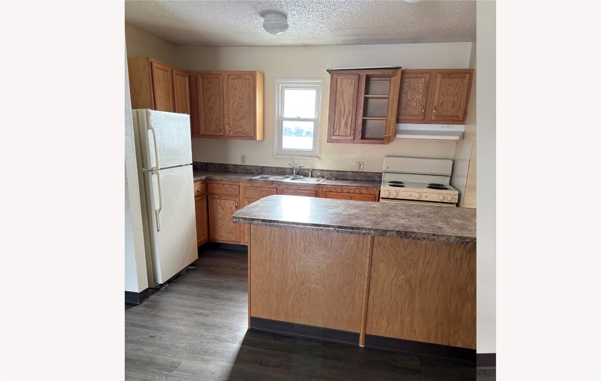 631 West Sycamore Street Columbus Grove, OH 45830 - Photo 8 of 10 a kitchen with stainless steel appliances granite countertop a sink and a refrigerator