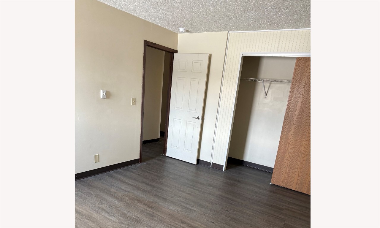 631 West Sycamore Street Columbus Grove, OH 45830 - Photo 9 of 10 a view of an empty room with wooden floor and closet