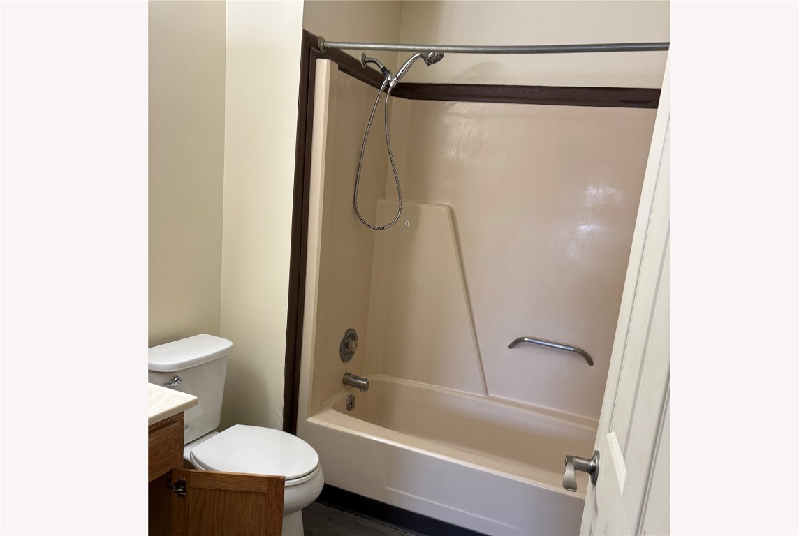 631 West Sycamore Street Columbus Grove, OH 45830 - Photo 10 of 10 a bathroom with a granite countertop toilet and a shower