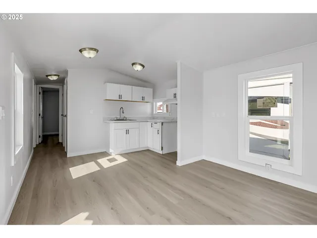 a view of a kitchen with wooden floor