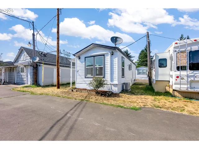 a view of a house with a backyard