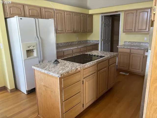 a kitchen with a stove a refrigerator and a sink
