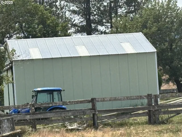 a backyard of a house with large trees and a yard