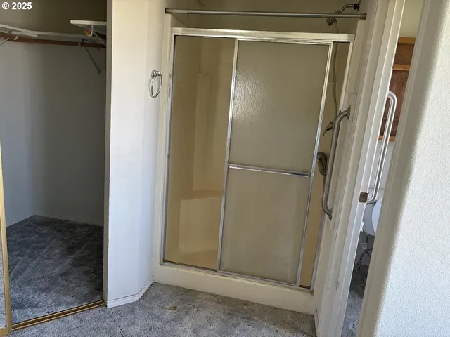 a bathroom with a glass shower door