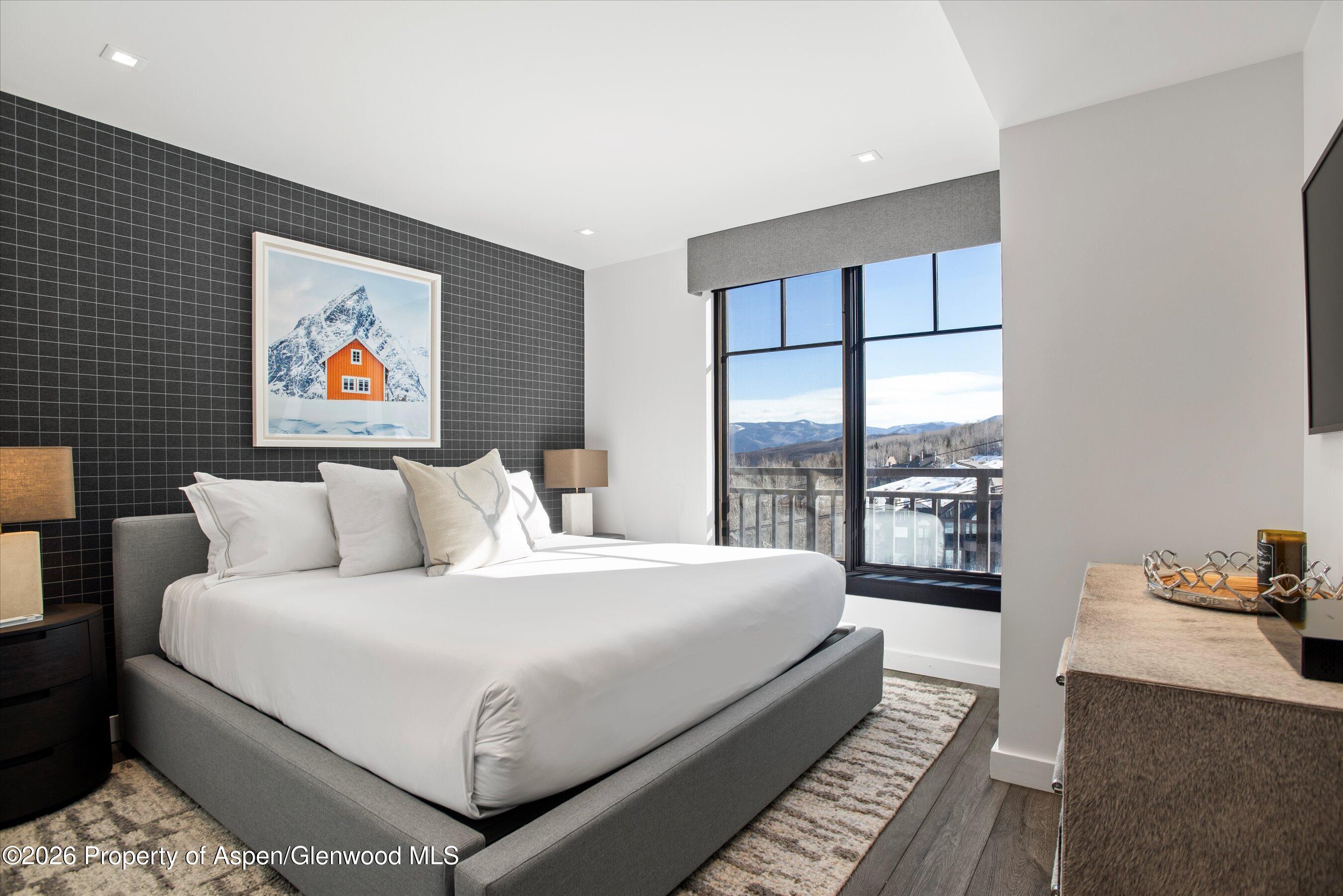 130 Wood Road, Unit 532 Snowmass Village, CO 81615 - Photo 12 of 15 a bedroom with a large bed and a balcony view