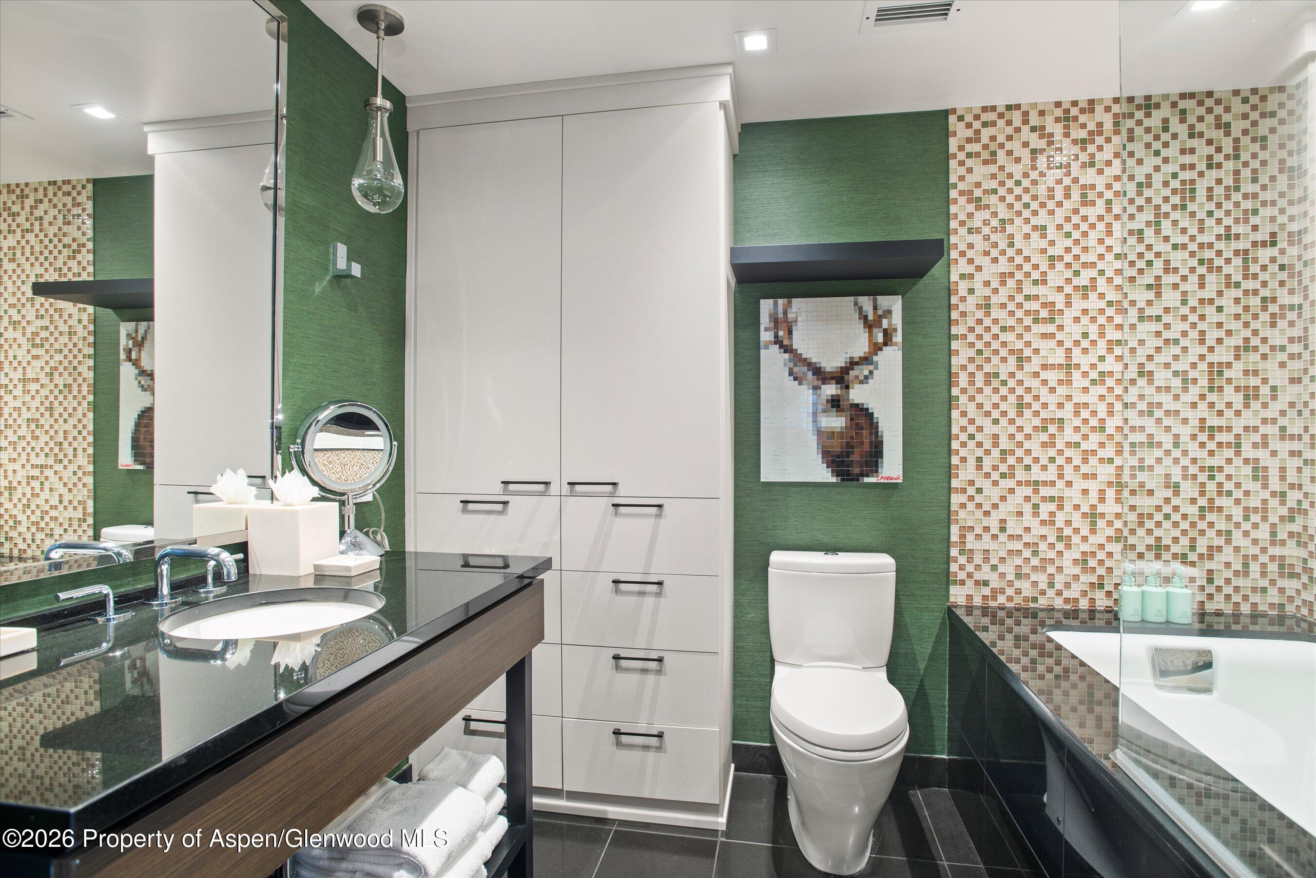 130 Wood Road, Unit 532 Snowmass Village, CO 81615 - Photo 13 of 15 a bathroom with a granite countertop toilet a sink and a bathtub