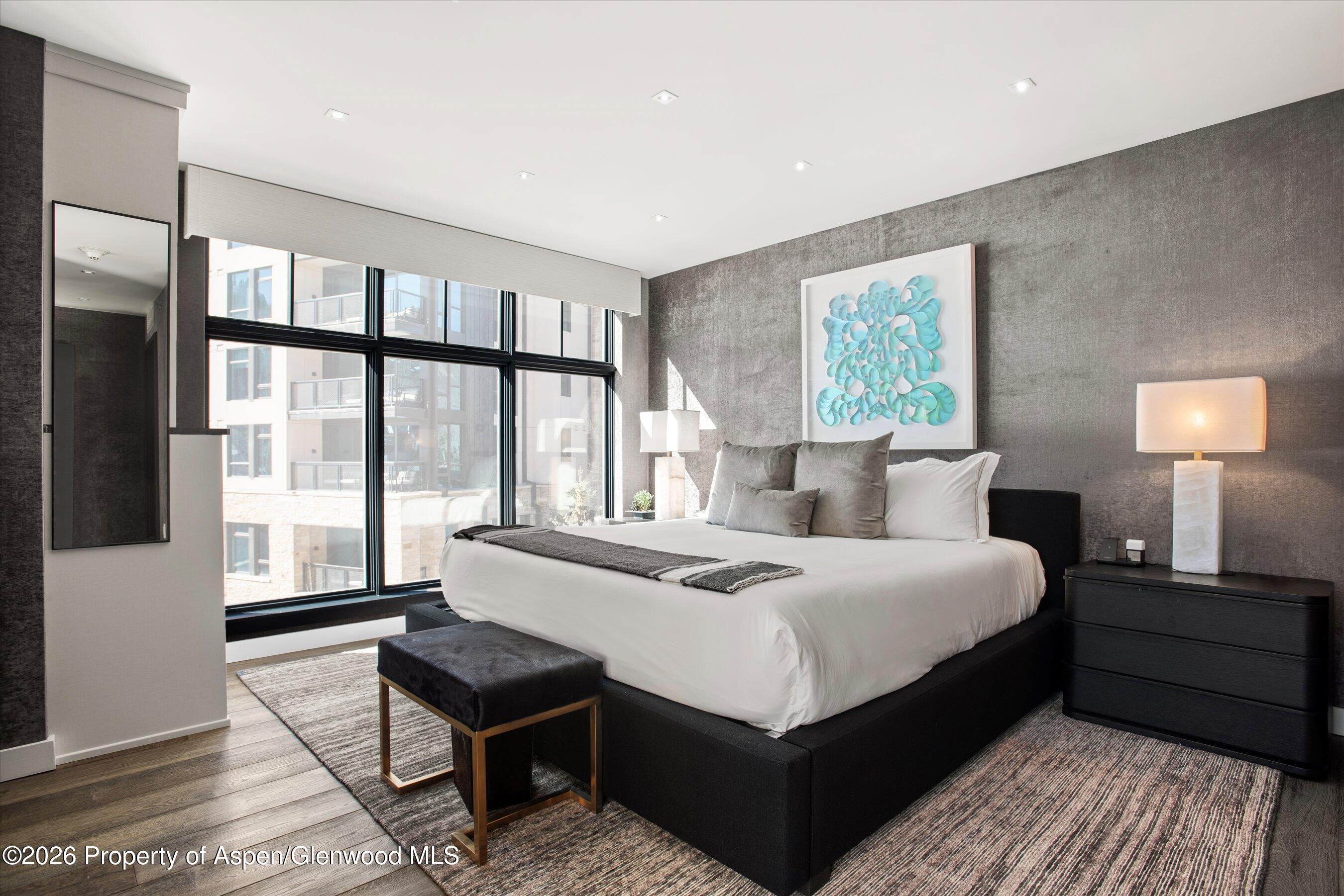 130 Wood Road, Unit 532 Snowmass Village, CO 81615 - Photo 9 of 15 a bedroom with a bed and a lamp on table