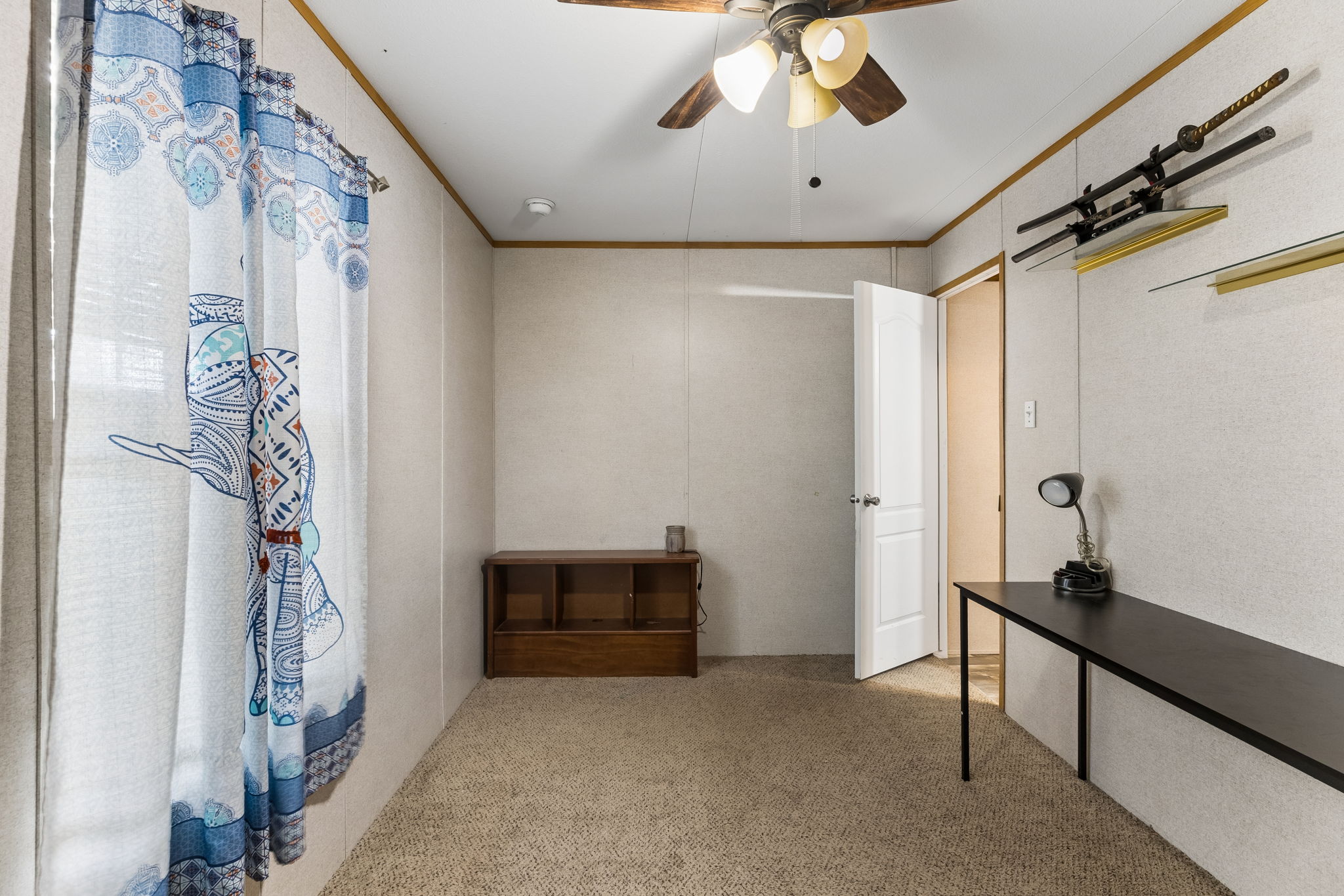 253 North County Line Road, Unit C Elgin, TX 78621 - Photo 22 of 39 A well-lit bedroom offering a cozy retreat with ample space for personalization.