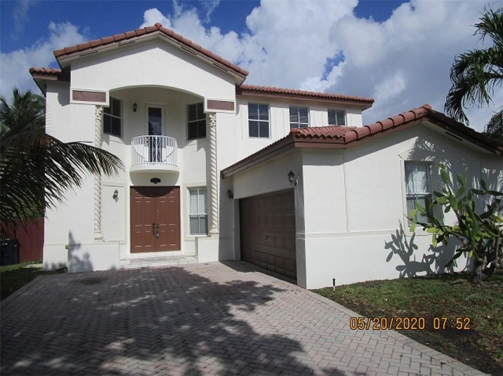 1734 Southwest 151 Place Miami, FL 33185 - Photo 1 of 12 a front view of a house with a yard