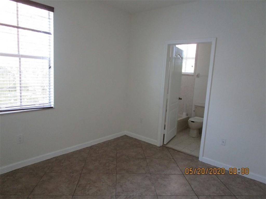 1734 Southwest 151 Place Miami, FL 33185 - Photo 12 of 12 an empty room with a window and a bathroom
