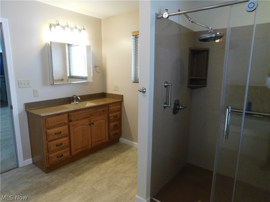 381 Lance Road Davisville, WV 26142 - Photo 13 of 34 View of one of the two Full Baths in the Master Suite area. Large walk in shower with glass doors and large shower head. Vanity is tall and lighting is very ample.