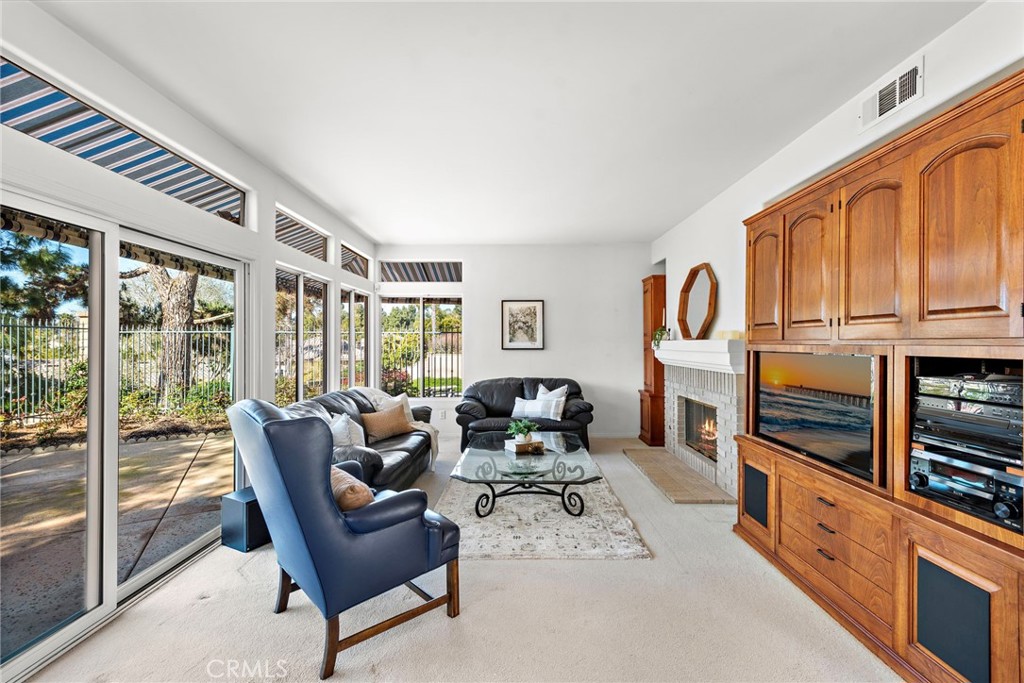 1775 Blackbird Circle Carlsbad, CA 92011 - Photo 17 of 32 a living room with furniture a fireplace and windows