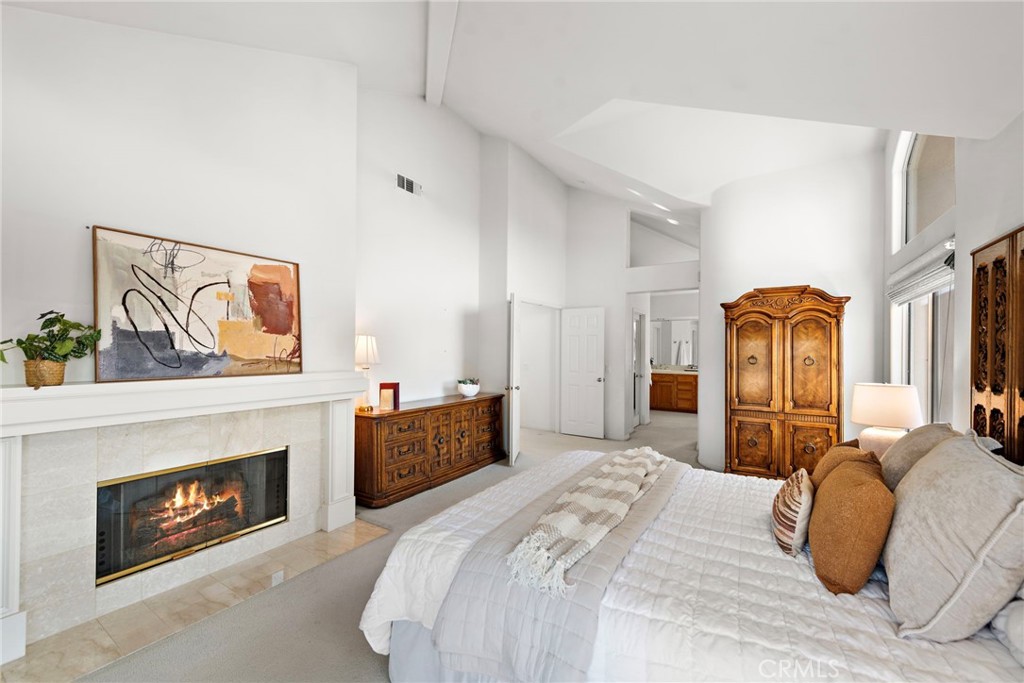 1775 Blackbird Circle Carlsbad, CA 92011 - Photo 25 of 32 a bedroom with a bed and a fireplace