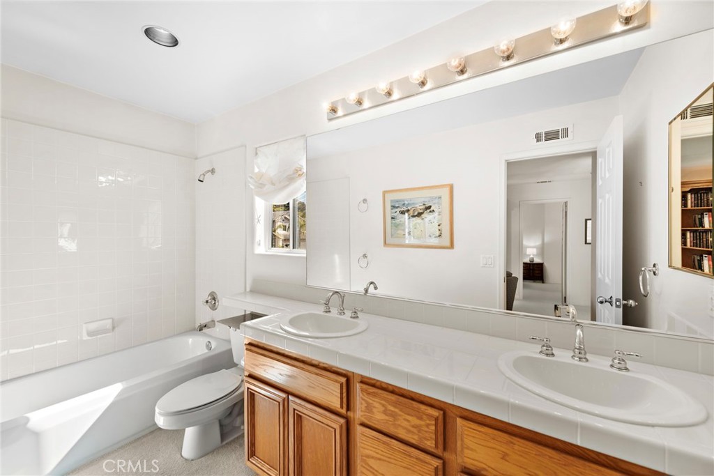 1775 Blackbird Circle Carlsbad, CA 92011 - Photo 32 of 32 a bathroom with a sink a toilet a shower and a mirror