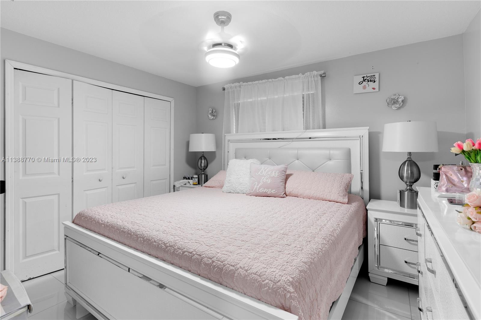 12458 Southwest 220th Street Miami, FL 33170 - Photo 13 of 25 a bedroom with a bed and a chandelier